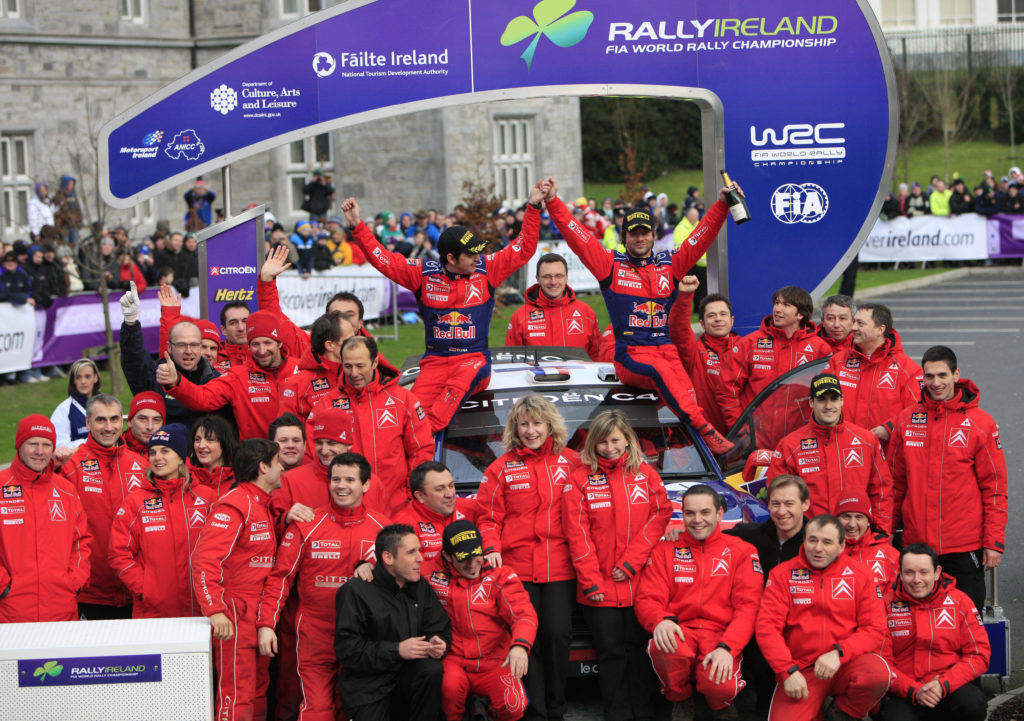 World champion Sebastien Loeb (R, on car