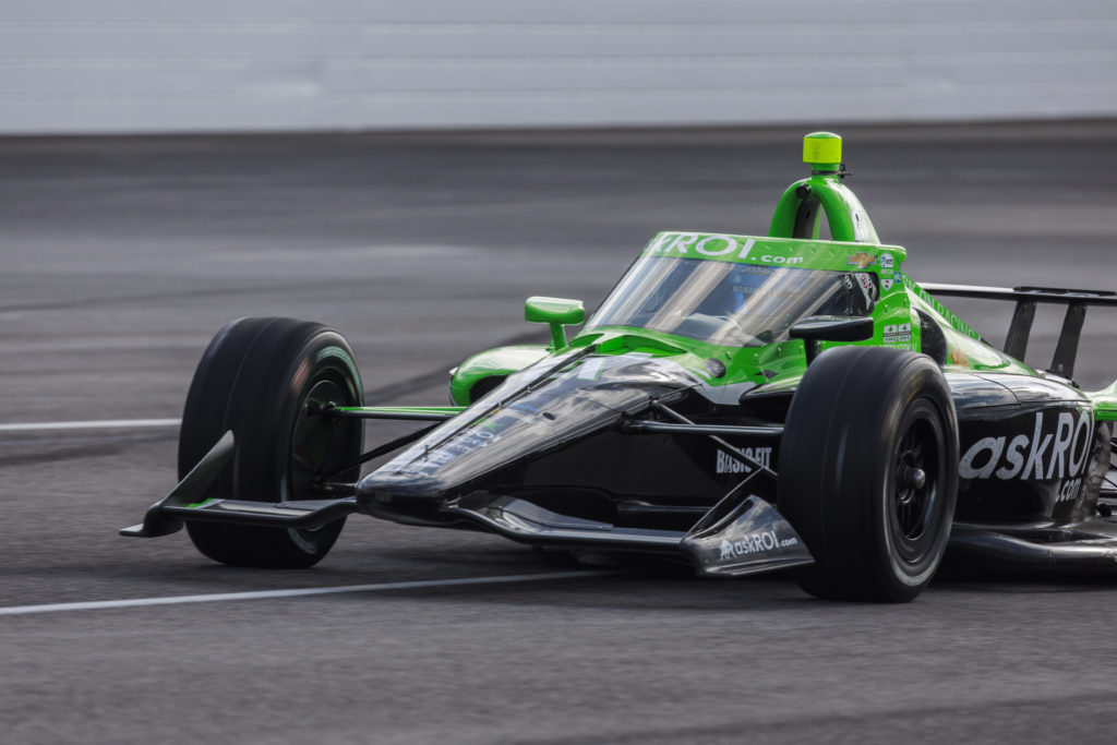 Race car driver Rinus VeeKay (21) drives through turn one